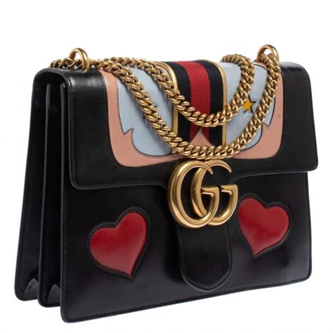 do real gucci bags have a heart on the back|gucci interlocking shoulder bag.